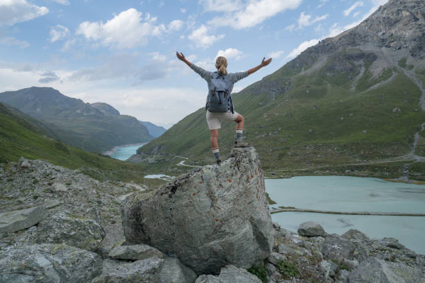 istock Hiker on top of rock arms outstretched 844045832