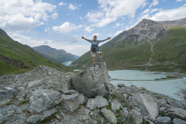 istock Hiker on top of rock arms outstretched 844045878