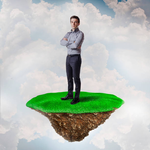istock Business man on grass island, business concept 844046272