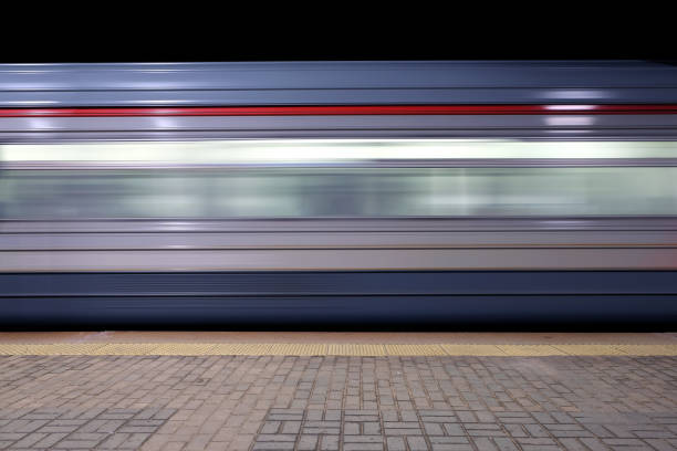 istock Blur motion of passenger train fast running beside railroad platform 844046484