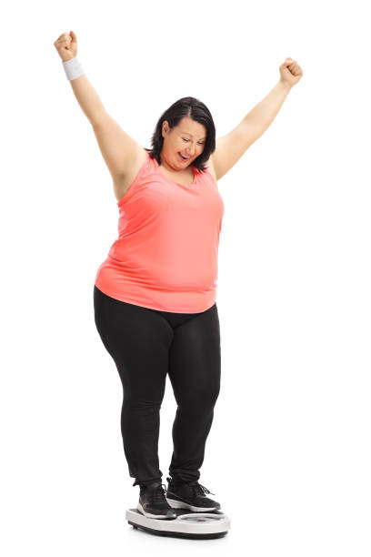 istock Overweight woman on a weight scale gesturing happiness 844046790
