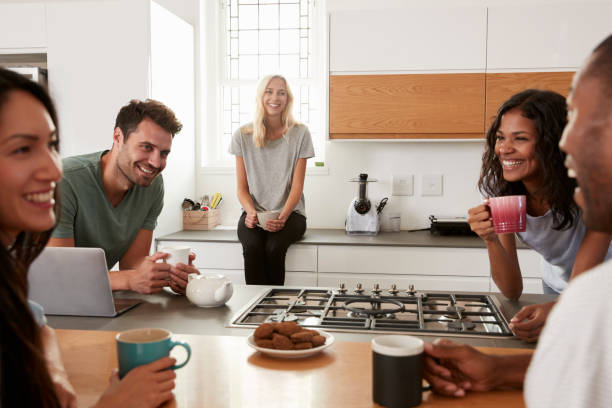 istock Friends Talking And Drinking Coffee In Modern Kitchen 844050508