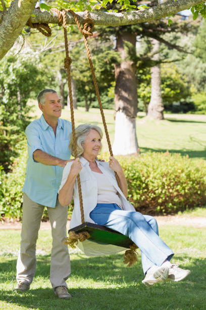 istock Mature couple at swing in park 844053358