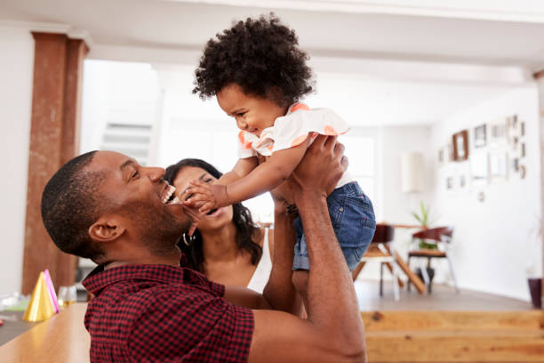 istock Parents Playing With Young Daughter At Home 844053368