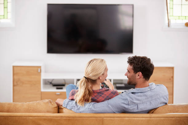 istock Rear View Of Couple Watching Television Together 844053576