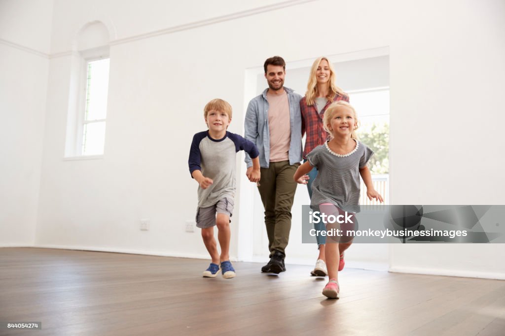 Excited Family Explore New Home On Moving Day Moving House Stock Photo