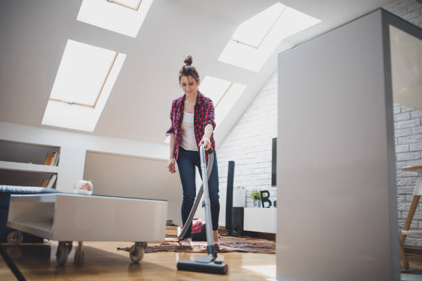 istock Woman cleaning living room 844054648
