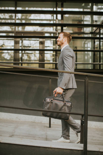 istock Young handsome man walking by office building 844054860