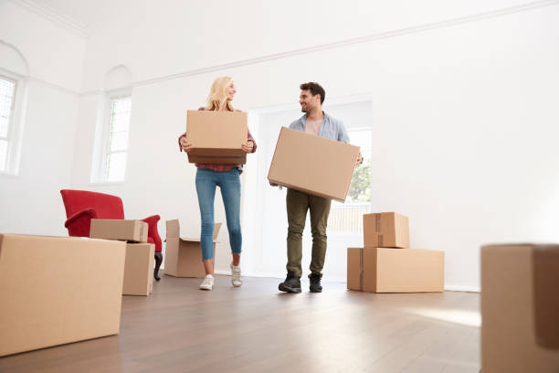 istock Couple Carrying Boxes Into New Home On Moving Day 844055110