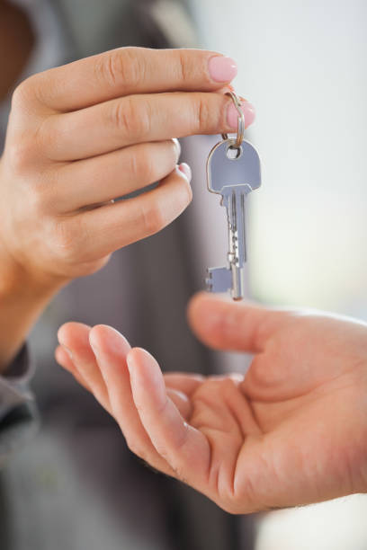 istock Estate agent giving house key to customer 844055862