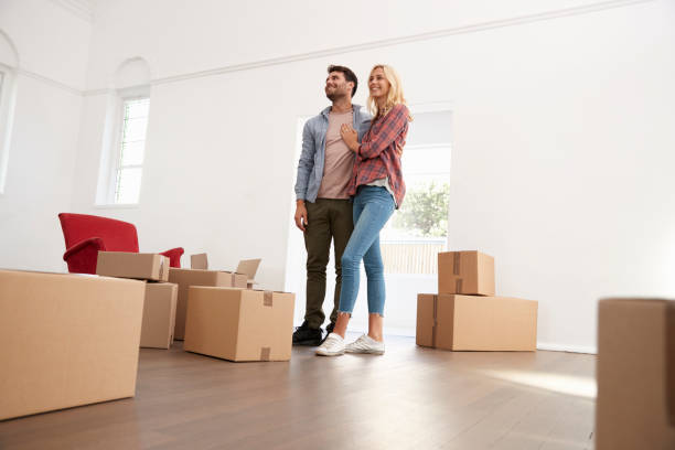 istock Couple Carrying Boxes Into New Home On Moving Day 844057174