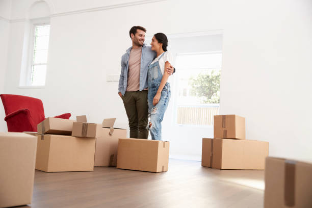 istock Couple Carrying Boxes Into New Home On Moving Day 844057320