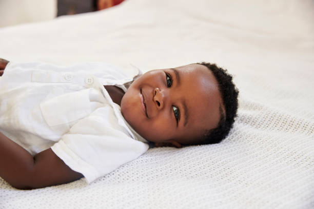 istock Overhead Shot Of Smiling Young Boy Lying On Bed 844057884