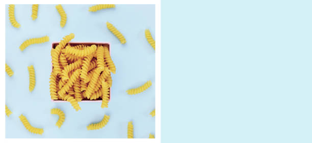 istock Uncooked italian pasta on blue background. 844058050