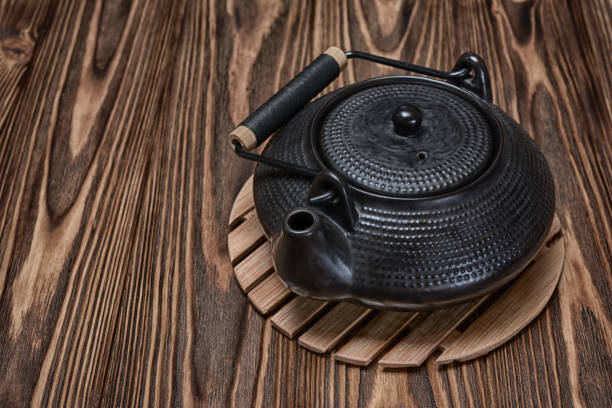 istock Asian black traditional teapot for tea ceremony on bamboo stand 844058650