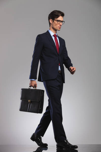 istock young businessman wearing glasses and suitcase is walking 844063934