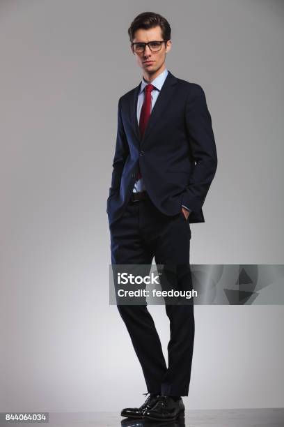 Young Business Man Standing With Hands In Pockets Stock Photo - Download Image Now - Suit, Full Length, Men