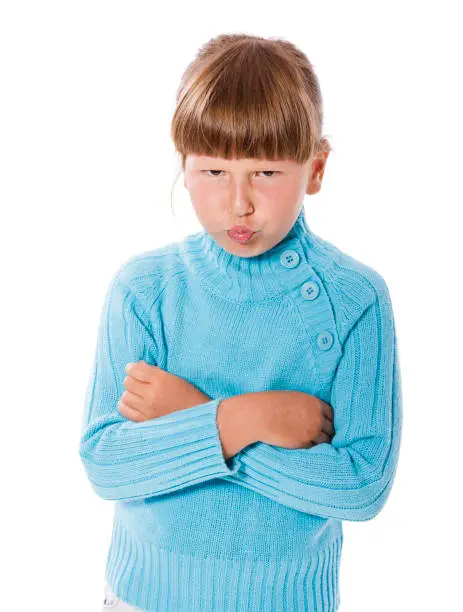 Upset cranky girl standing crossed hands isolated on white background