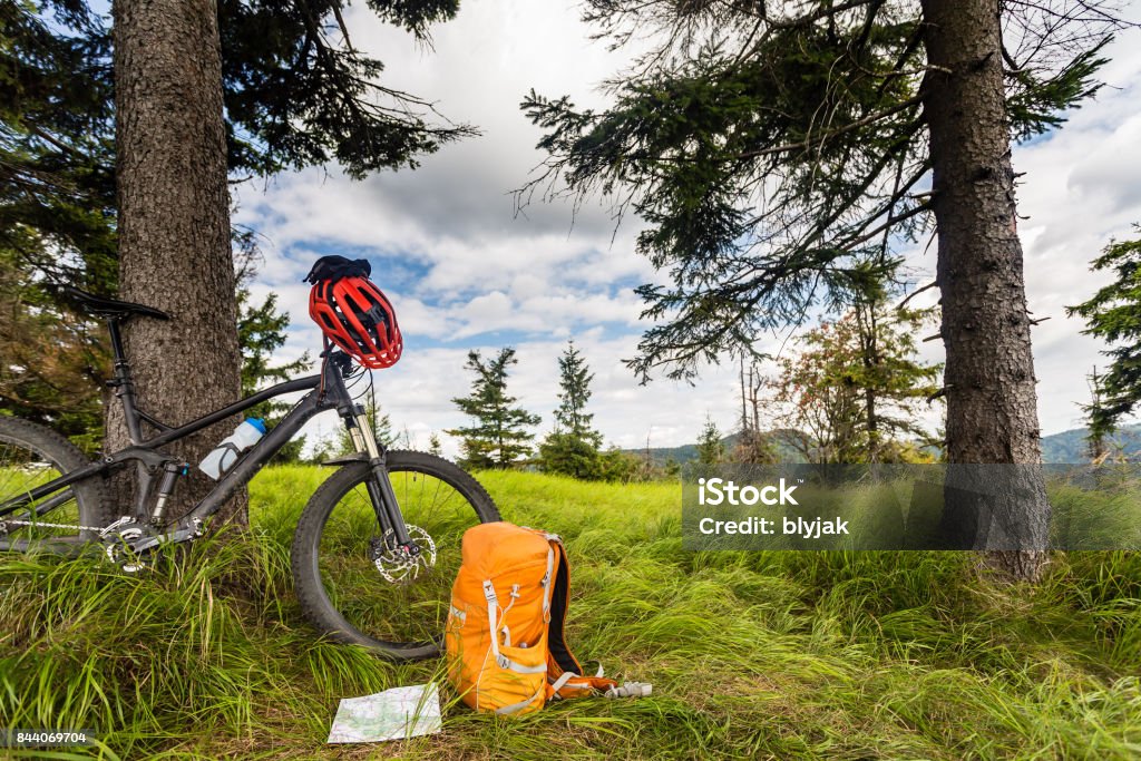 Mountain biking equipment in the woods, bikepacking Mountain biking equipment in the woods, bikepacking adventure trip in green mountains. Travel campsite and MTB cycling with backpack, wilderness forest in Poland. Cycling Stock Photo