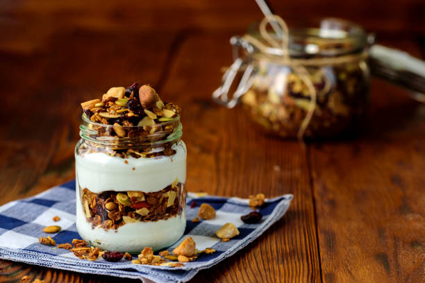 istock Granola with yogurton wooden table. 844070588