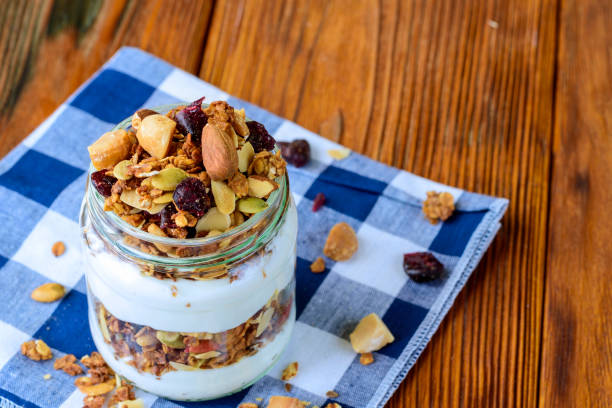 istock Granola with yogurt on wooden table. 844070694