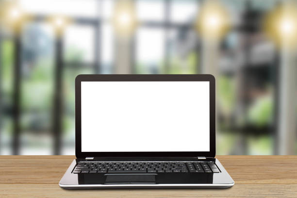 istock Laptop with blank white screen on vintage wooden table on blurred modern office background 844082180