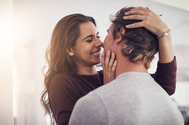 I just want to eat you up Cropped shot of an affectionate young couple at home clingy girlfriend stock pictures, royalty-free photos & images