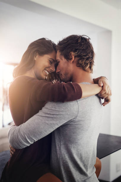 We fall deeper in love each day Cropped shot of an affectionate young couple at home clingy girlfriend stock pictures, royalty-free photos & images