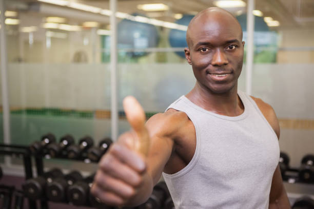 istock Muscular man giving thumbs up in gym 844091578