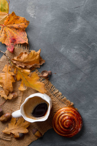 istock Hot coffee in mug with cinnamon bun and autumn leaf 844091610