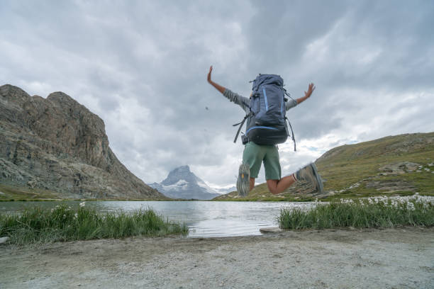 istock Female hiker jumping at Matterhorn, Switzerland 844091684