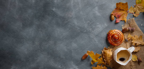 istock Hot coffee in mug with cinnamon bun and autumn leaf 844091880