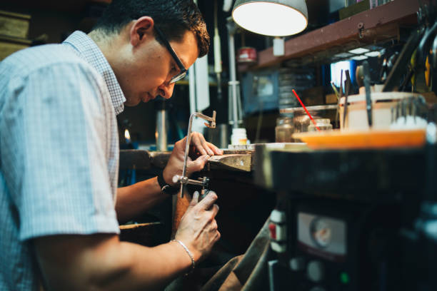 istock Jeweler desining jewelry in workshop 844092786
