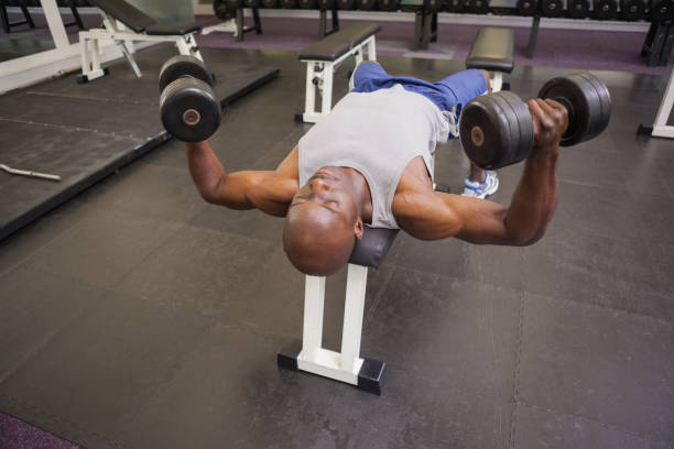 istock Muscular man exercising with dumbbells 844095116