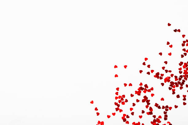 small hearts on a white background - heart shape confetti small red imagens e fotografias de stock