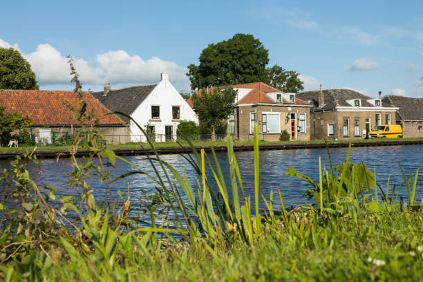 istock Dutch typical houses by the river bank 844095990