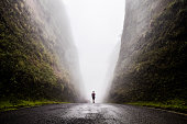Walking into the unknown, walking between two huge cliffs of rock while a cloud passes in between of them, Urubici, South of Brazil, Brazil, South America.