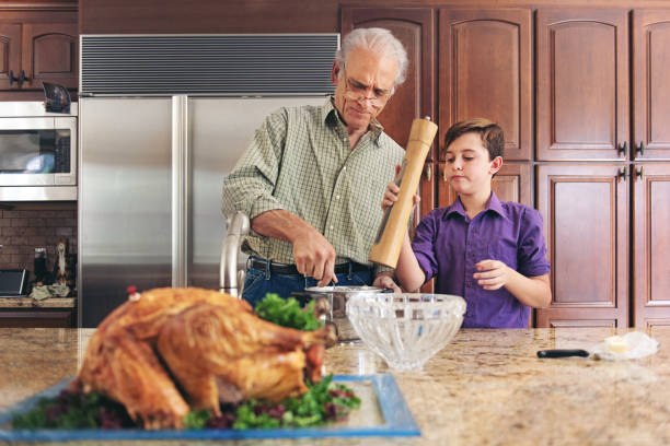 istock Grandfather and grandson preparing thanksgiving dinner 844098866