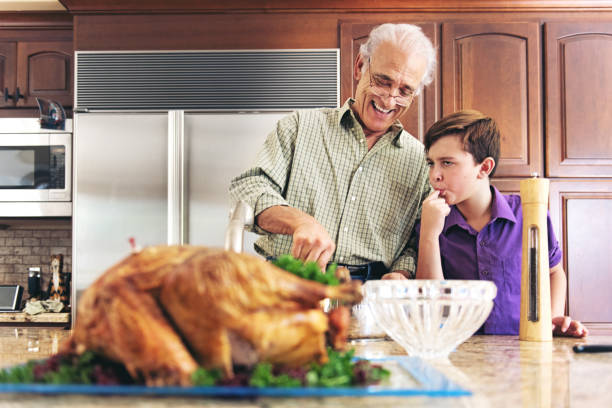 istock Grandfather and grandson preparing thanksgiving dinner 844098868