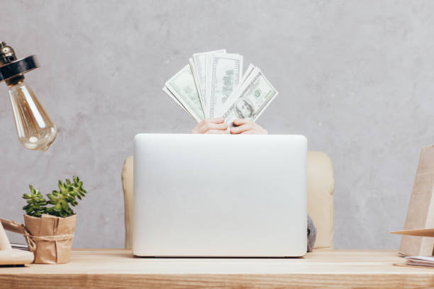 istock child with money hiding behind laptop 844102566