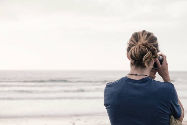 istock Man taking photograph at the beach. 844103546