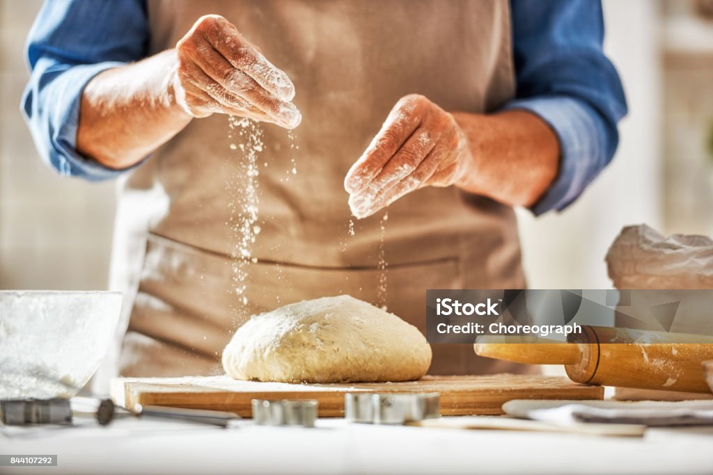 Hands preparing dough Close up view of baker is working. Homemade bread. Hands preparing dough on wooden table. Bread Stock Photo