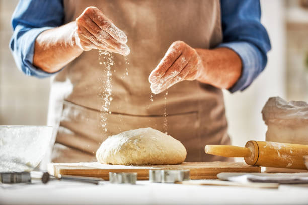 Hands preparing dough Close up view of baker is working. Homemade bread. Hands preparing dough on wooden table. flour stock pictures, royalty-free photos & images