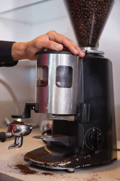 istock Barista using coffee grinder to grind beans 844114040