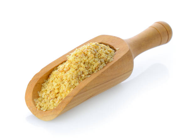 istock Wheat germ in wood scoop on white background 844121342