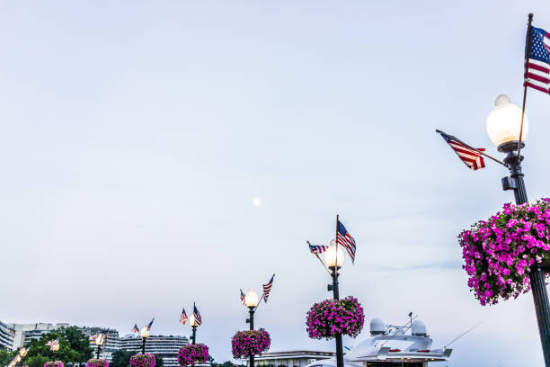 istock Georgetown waterfront harbor park decorations on riverfront in evening with potomac river, boat and full moon in Washington DC 844125272