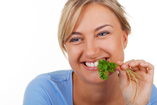 istock Happy woman tries parsley 844125388