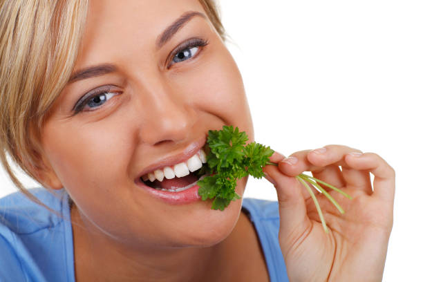 istock Happy woman tries parsley 844125434