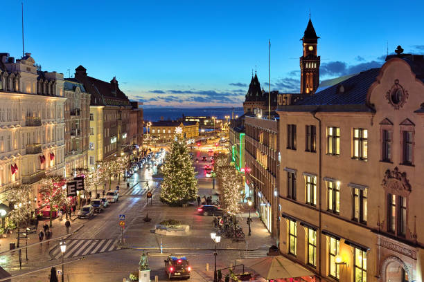 Helsingborg, Sweden - December 11, 2015: Evening view of Stortorget square with Christmas Tree, Tower of the City Hall, Oresund strait and Danish coast. Stortorget square is the main city's square; it was built in 1693. The official Helsingborg Christmas tree always stands here.