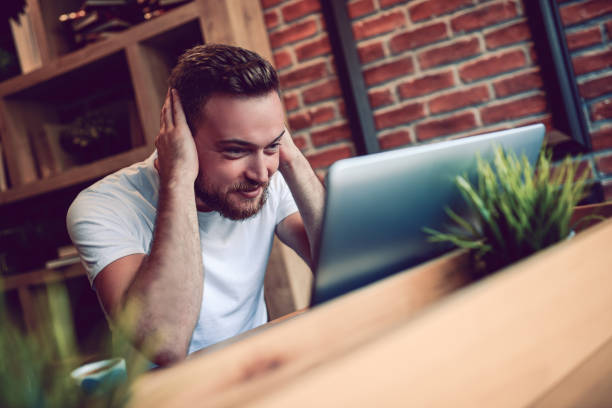 istock Young Smiling Freelancer Working on Project in Modern Cafe Restaurant 844125662
